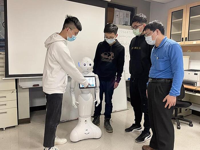 同學在林詩偉(右一)老師指導下開發系統，讓Pepper機器人勝任大樓管理員工作